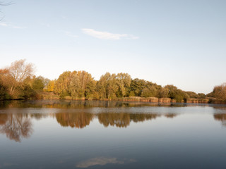beautiful lake landscape water surface with autumn trees and reeds