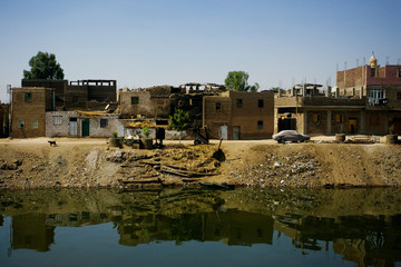 Group of small poor homes along the banks of the Nile