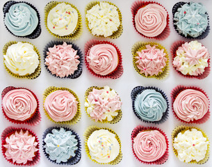 Set of different delicious homemade cupcakes in paper delivery box. Top view.