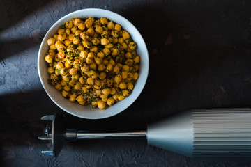 Chickpeas in a ceramic bowl and blender for making falafel free space