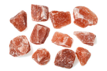 Himalayan pink rock salt isolated against white background.