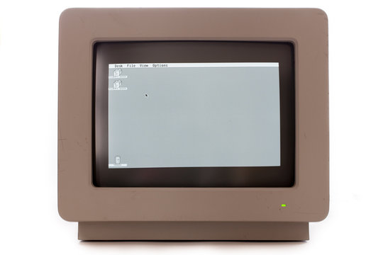 Vintage computer monitor display. Retro cathode ray tube monochrome screen monitor showing floppy disk drive icons and trash can.