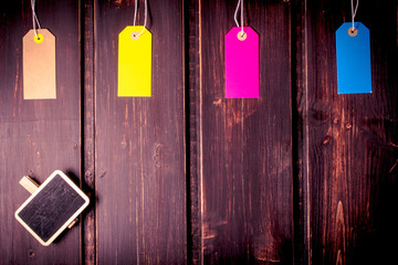 Multicolor sale tags or label on dark wooden background