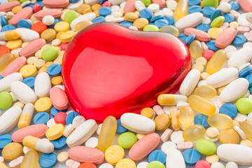 Fototapeta na wymiar heart with pills. colorful pills. medical background
