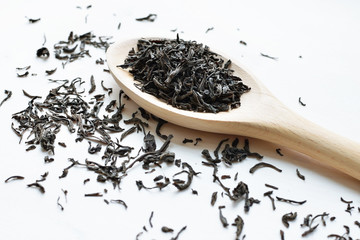 black tea in wooden spoon