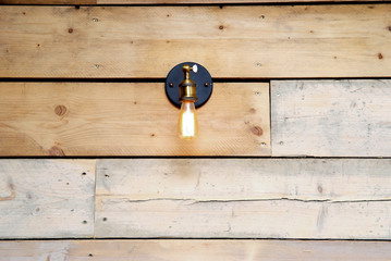 Spot light on a wooden interior wall