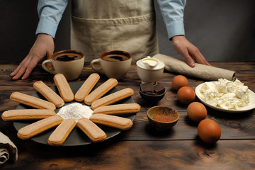 The recipe for tiramisu preparation, part one "a set of products". Products: Coffee strong, savoiardi Cookies, cream, chocolate bitter, egg chicken, cocoa, icing sugar, mascarpone cheese.