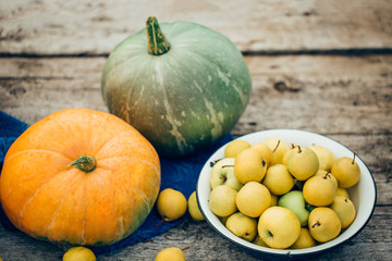 Autumn harvest on the table, apples, pumpkins, wooden background