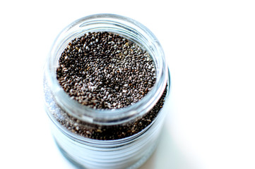 Chia seeds in a glass jar, top view, close-up