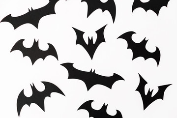 Halloween homemade paper black bats isolated on white background. Flat lay, top view.