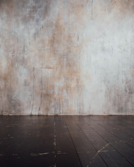 aged planks floor and concrete wall background, focus on foreground