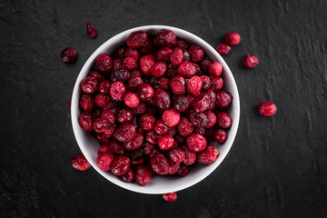 Slate slab with Dried Cranberries (selective focus; close-up shot)