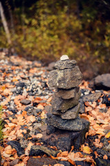 Stones pyramid on pebble beach symbolizing stability, zen, harmony, balance. Shallow depth of field.