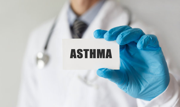 Doctor holding a card with text ASTHMA, medical concept