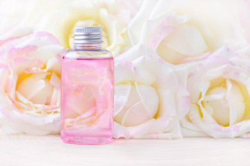 natural cosmetic bottle with fresh rose flowers, organic beauty