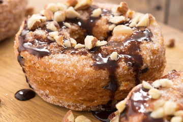 donuts chocolate with sprinkles on wood