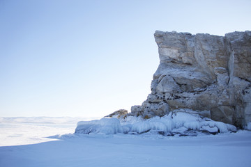 Small rocky island of lake Baikal. Winter landscape