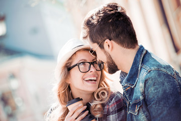 Coffee love concept. Young couple in park with coffee to go.