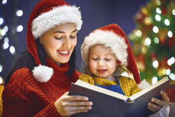 Fototapeta na wymiar mother reading a book at Christmas