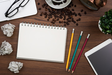 Laptop and coffee cup on wooden table with copy space