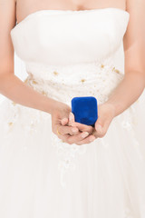 Portrait of beautiful asian bride in white gown holding wedding ring in hand isolated on white background.  Asian model wearing gown in studio.