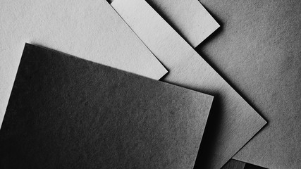 Minimal style papers in dark noir light room. Office supplies top view.