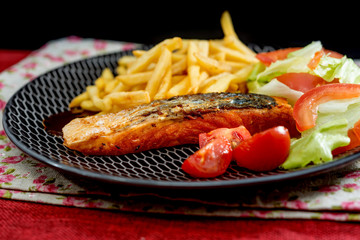 grilled salmon with sauce lemon and tomato
