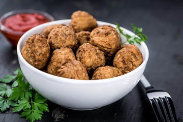 Meatballs on a vintage looking slate slab (selective focus)