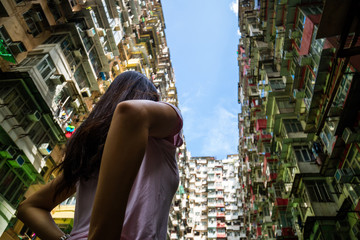 Asian girl tourist visit Transformer building apartment, famous Hong Kong landmark in Quarry Bay,...