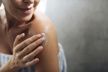 Woman Applying Moisturising Creme on Her Body
