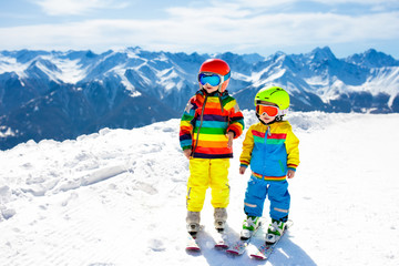 Fototapeta na wymiar Ski and snow winter fun for kids. Children skiing.