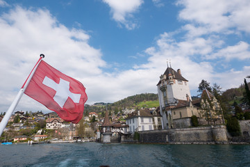 Lake Lucerne sunny day with blue sky and clouds with Swiss flag, Switzerland