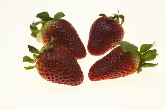 Juicy berries of a ripe strawberry on a white background.