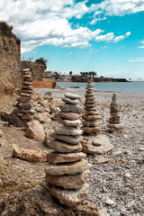 Fototapeta na wymiar A stone pile on the sea beach. Stone tower closeup.