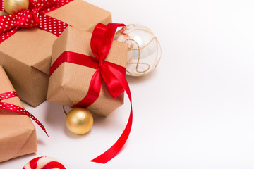 Christmas gift boxes wrapped in craft paper with satin red ribbon bow for christmas present...