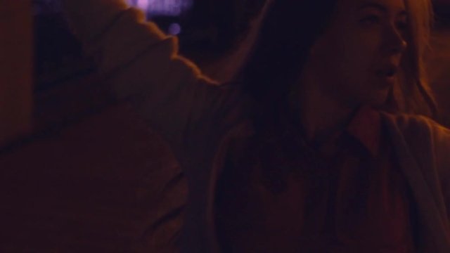 a young and sensual woman, an Asian woman with long hair, dances in the night bustle against the backdrop of a glowing fanfare. A sportive style of clothing. bright night illumination and a luminous