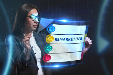 The concept of business, technology, the Internet and the network. A young entrepreneur working on a virtual screen of the future and sees the inscription: Remarketing