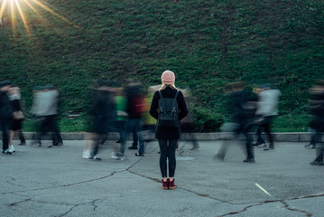 women on the street with passing people, photo on long exposure