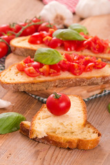 Fototapeta na wymiar Bruschetta bread with basil and chopped tomatoes. 