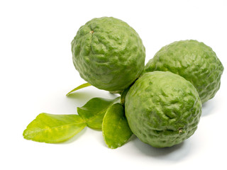 close up group of fresh bergamot with green leaves isolated on white background. benefits of bergamot for beauty and health concept