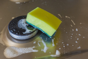 Detergent with foam and sponge on electric hob. For electric cooker applied for washing grease and rust