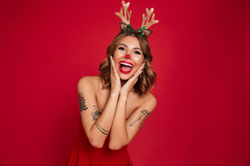 Portrait of a cheerful young girl wearing christmas deer costume