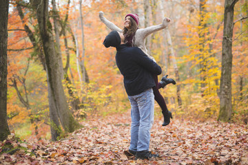 Young couple in love in a park on a autumn day