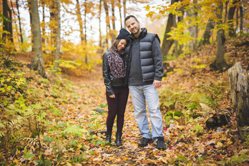 Young couple in love in a park on a autumn day