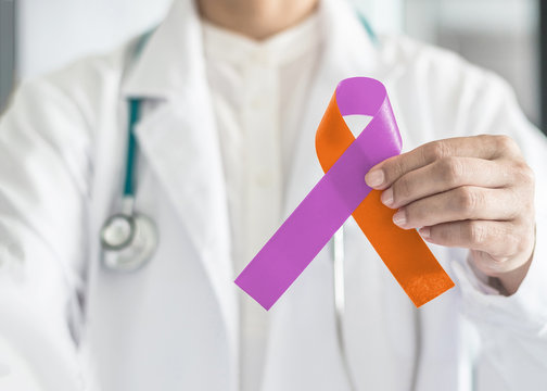 Psoriasis illness and Eczema Dermatitis skin disease awareness campaign concept with orchid purple orange ribbon symbolic bow color on doctor's hand support