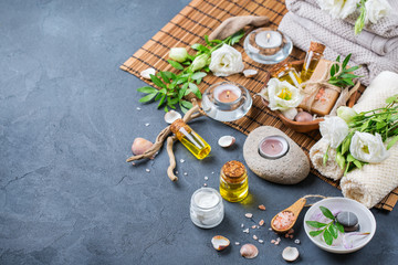 Spa wellness setting concept with spring flowers, black background