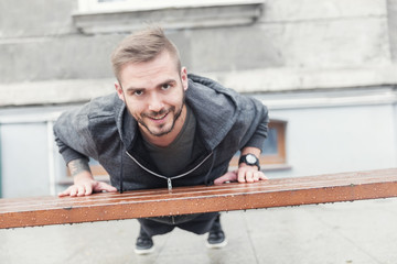 Active man doing sports. City workout.