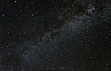 Constellation Cassiopeia in the band of the Milky Way galaxy with the Andromeda Galaxy visible near the lower edge