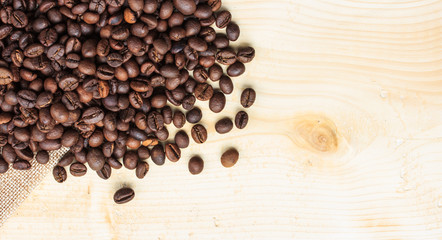 Roasted coffee beans on wooden background