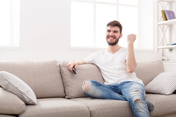 Man watching sports on tv and supporting team